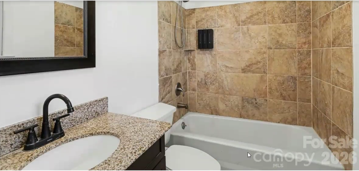 Tiled bathroom with tub and shower