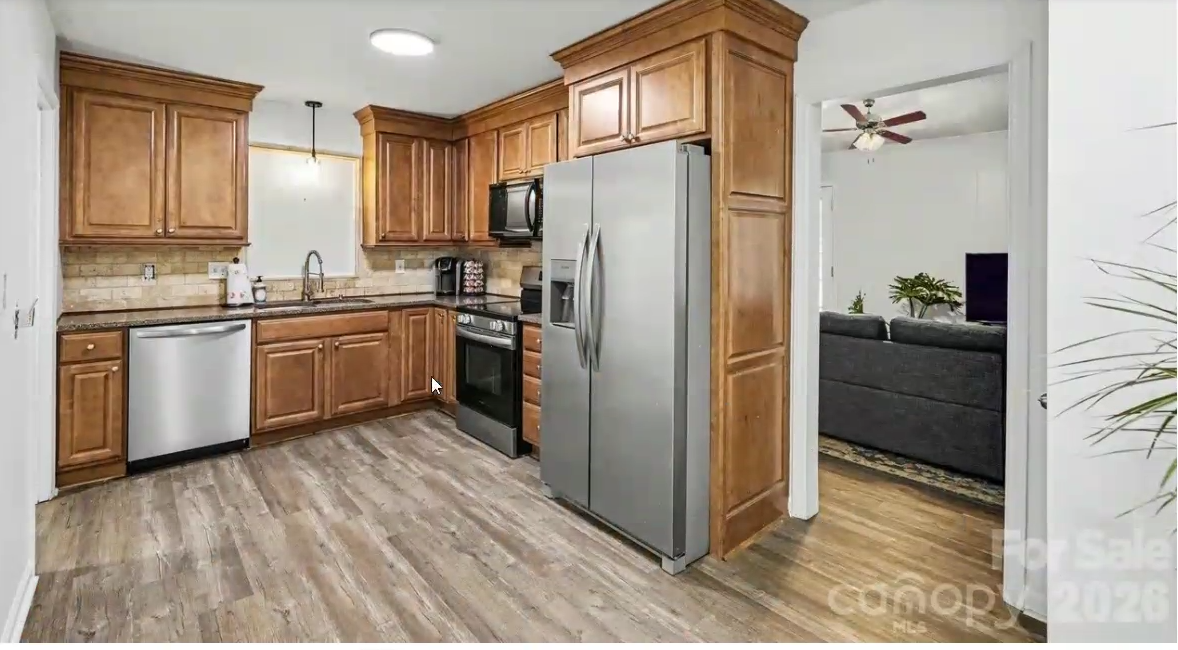 Open kitchen with wood cabinetry