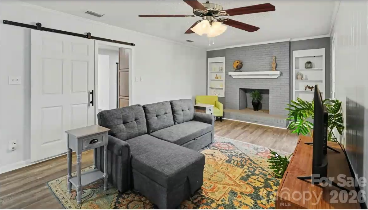 Living room with fireplace and built-in shelving