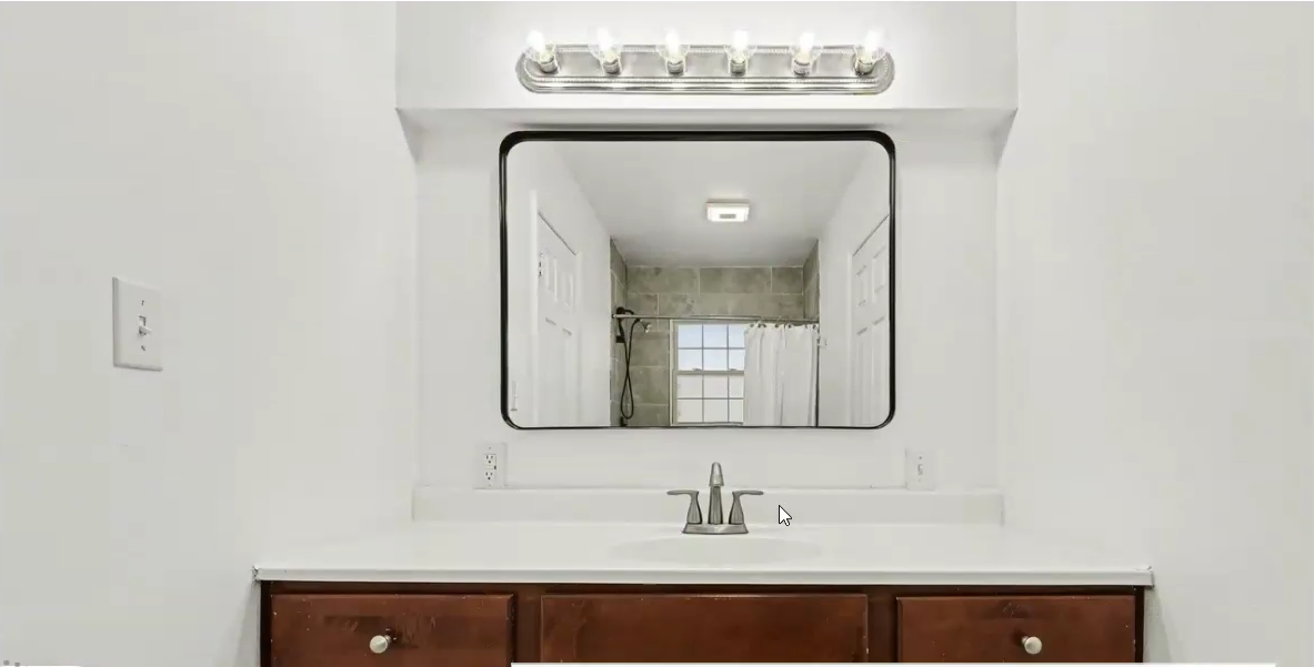 Bathroom vanity with large mirror